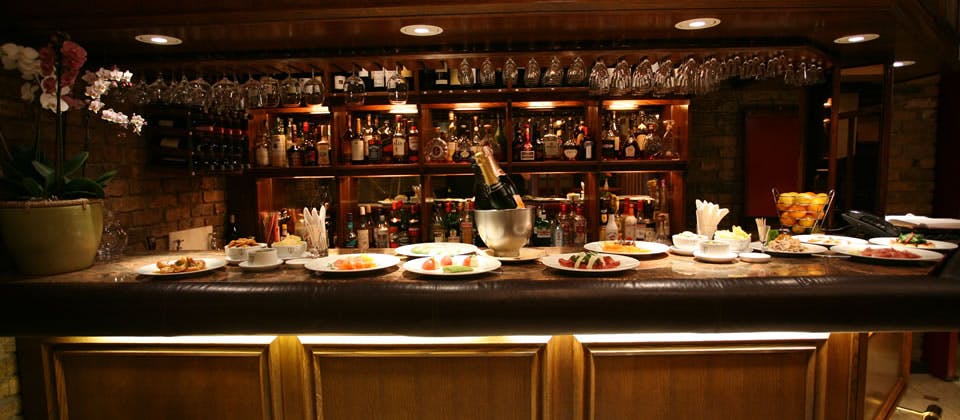 Elegant bar setup with champagne and appetizers for networking events in Bolton's restaurant.