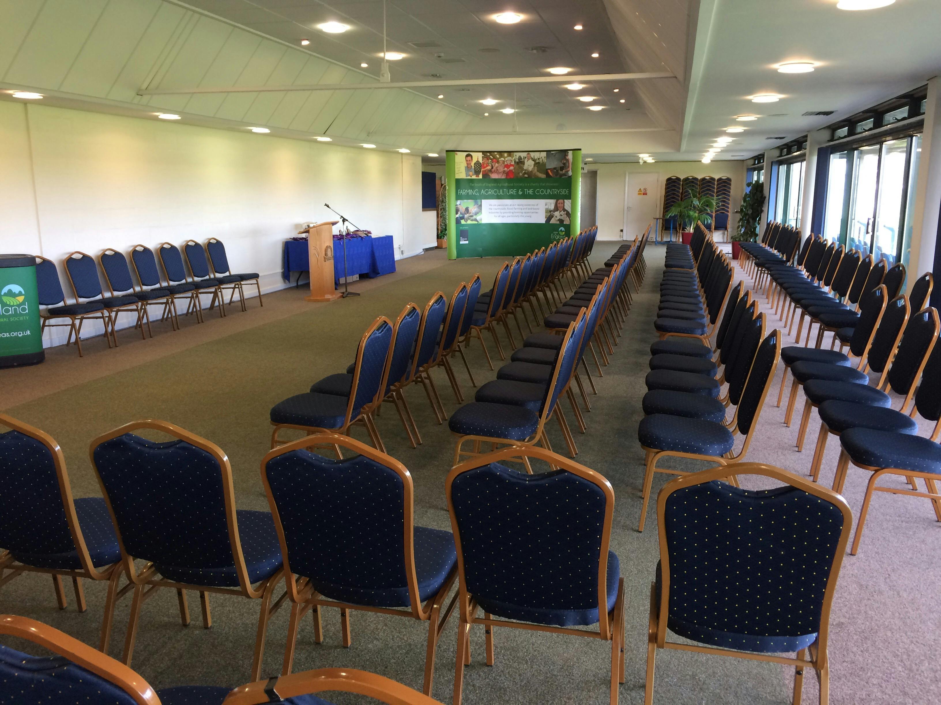 Balcombe Room setup for a conference with chairs and podium in South of England Event Centre.