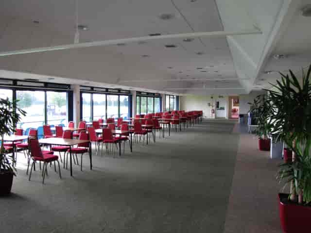 Balcombe Room: spacious event venue with red chairs for meetings and conferences.