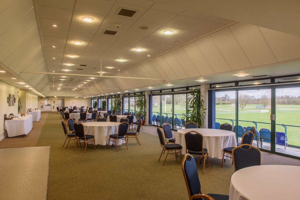 Balcombe Room: spacious event venue with round tables, ideal for corporate meetings and gatherings.