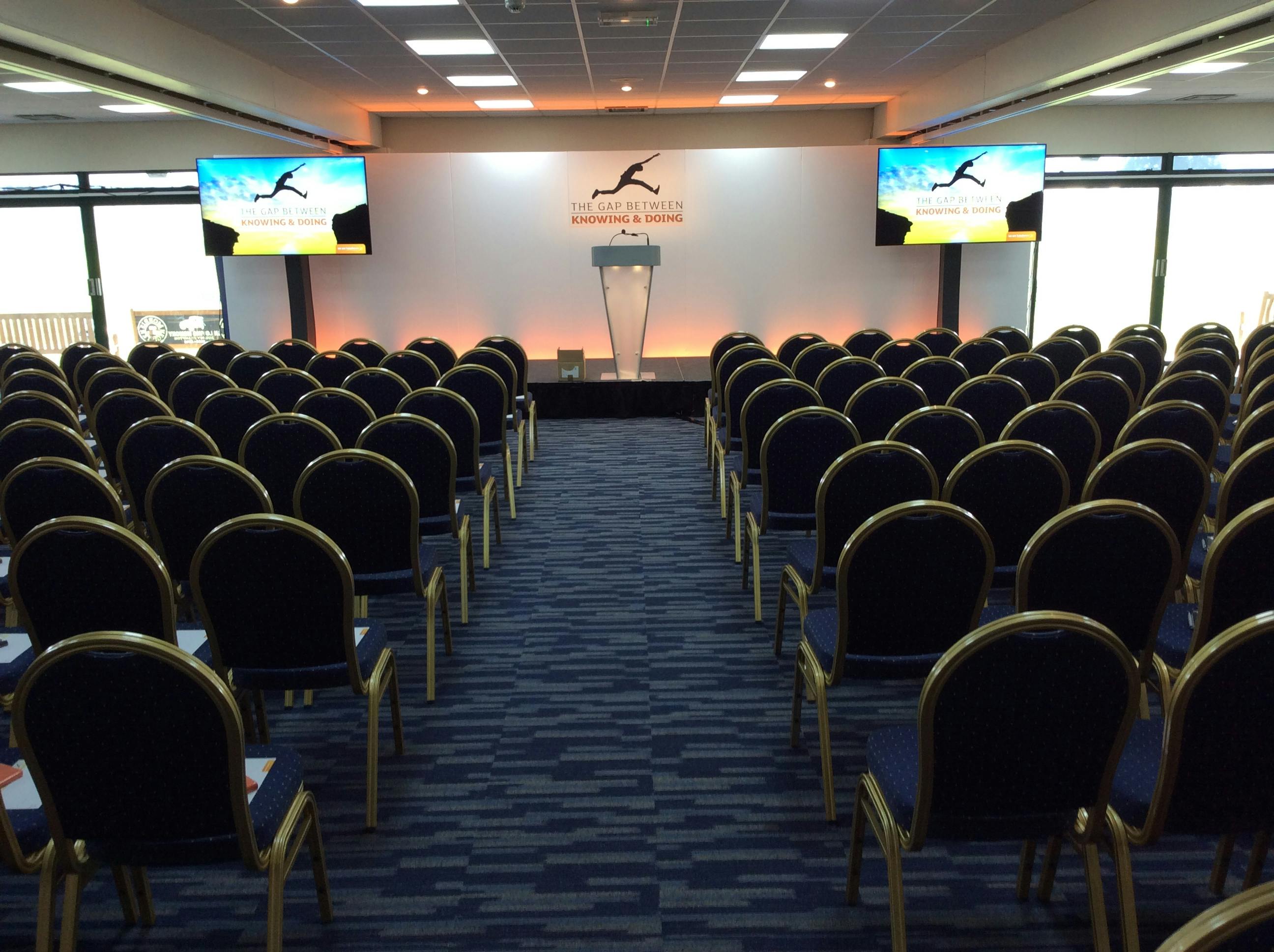 Ardingly Room conference setup with podium, ideal for corporate events and presentations.