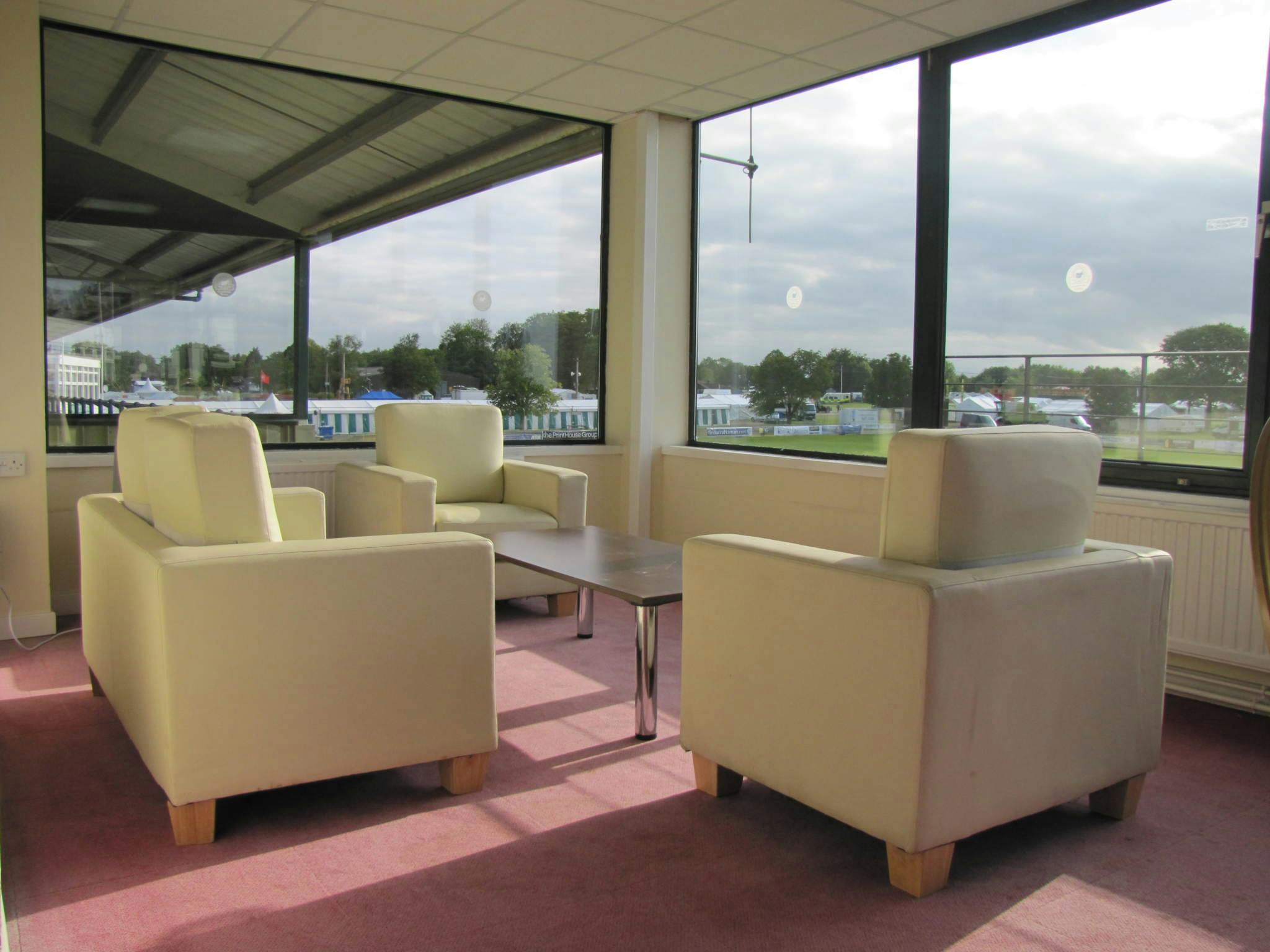 Modern meeting space with white armchairs for networking at South of England Event Centre.