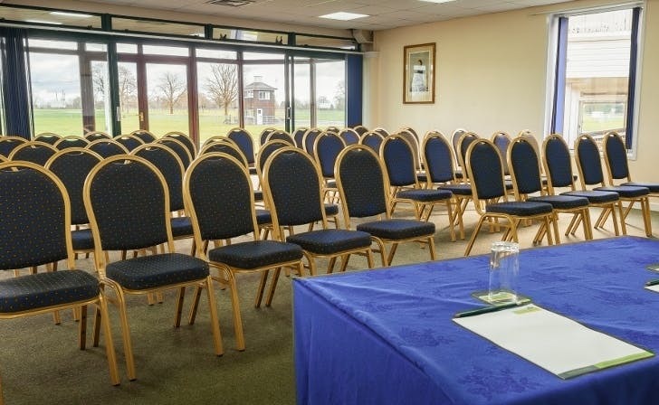 Lower Queen's Room setup for workshops with natural light and arranged chairs.