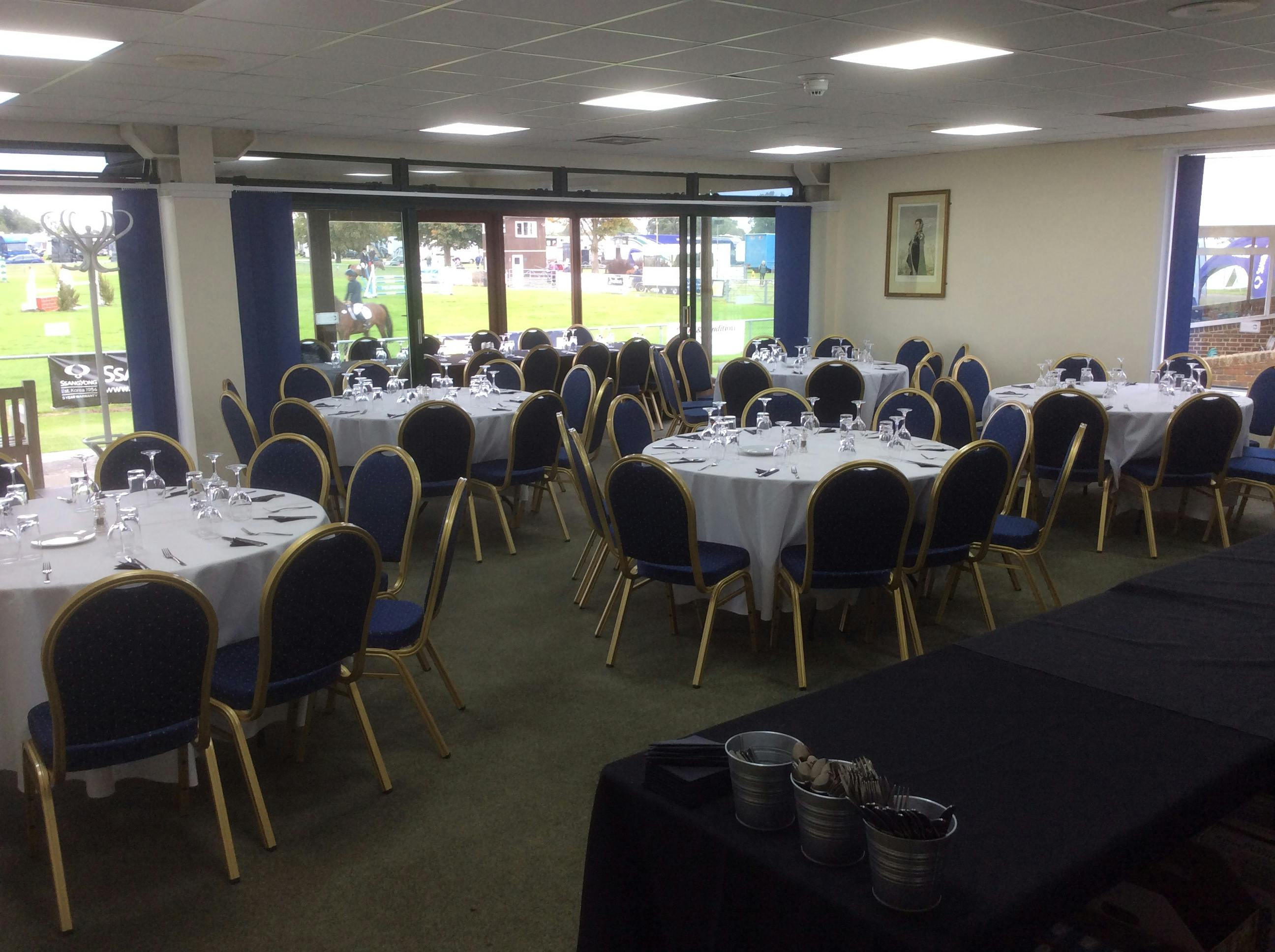 Lower Queen's Room with round tables, ideal for formal dinners and networking events.