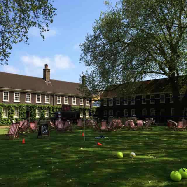Charming outdoor venue with lush lawn for summer events and team-building retreats.