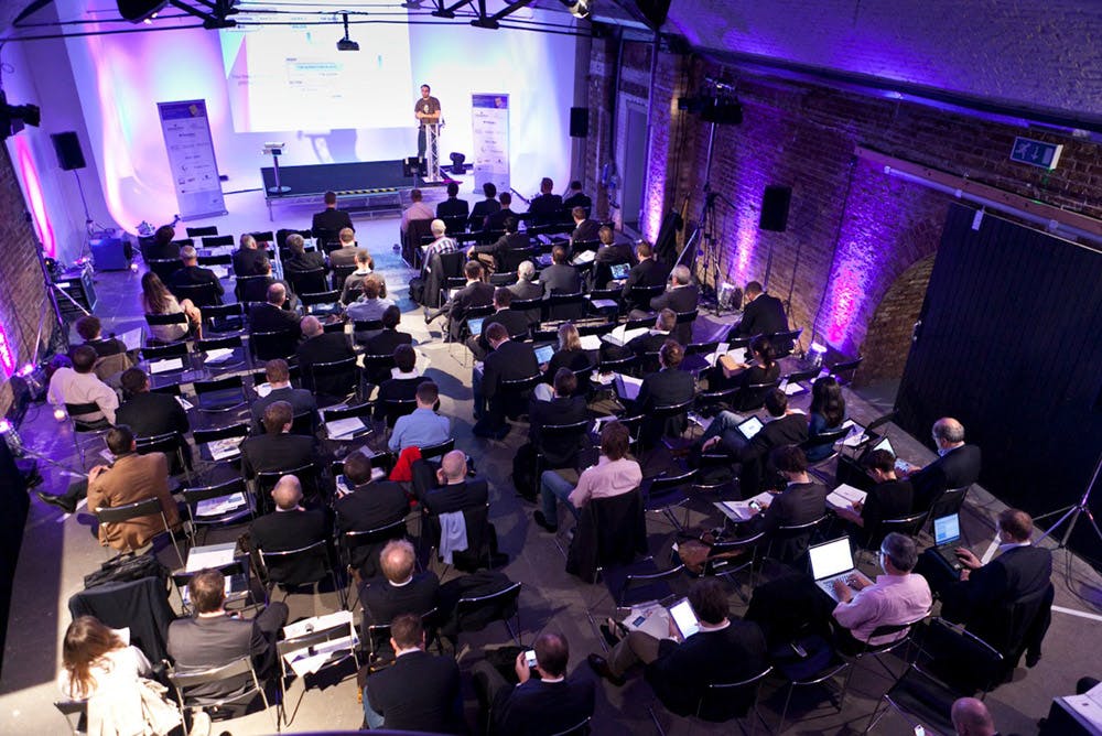 Conference in Shoreditch Studios with modern lighting and engaged audience.