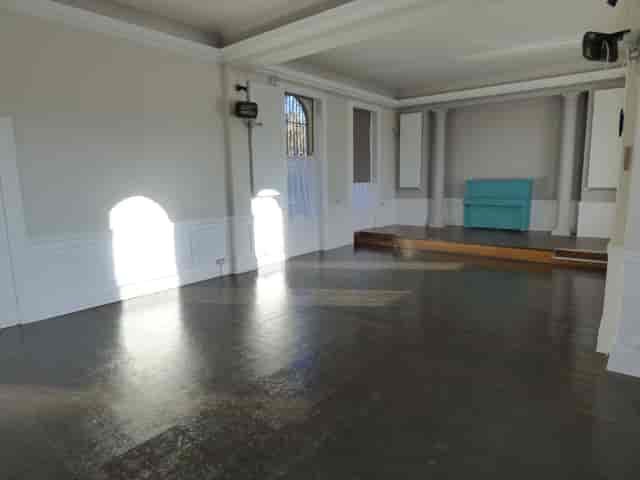 ETNA Community Centre hall with stage, perfect for workshops and boutique event receptions.
