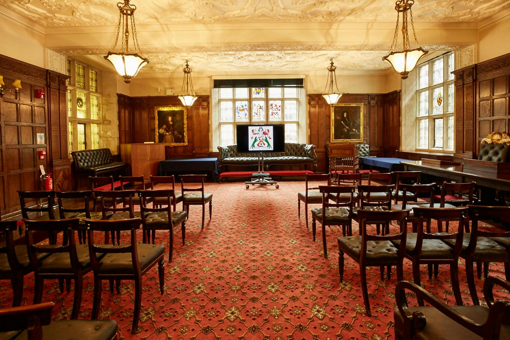 Elegant meeting room with wood paneling, ideal for corporate events and workshops.