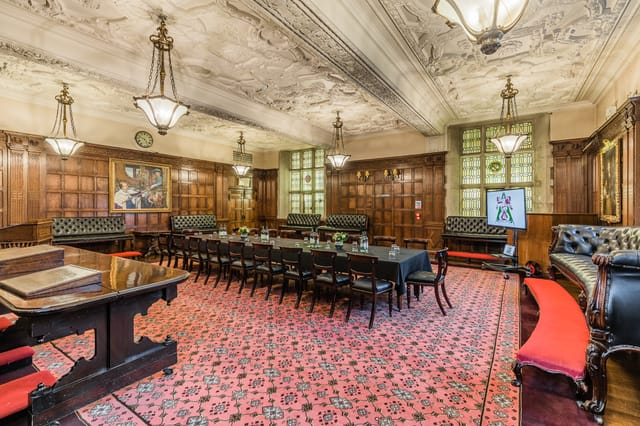 Elegant meeting room with wood paneling, ideal for high-level meetings and events.