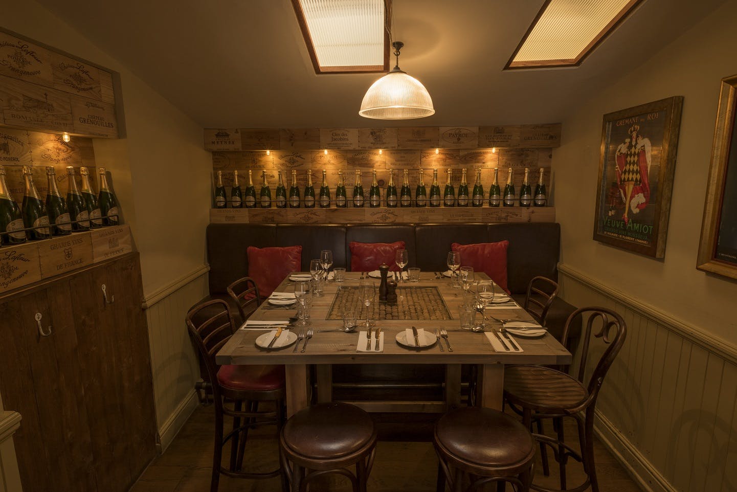 Intimate dining space with champagne display for private events at Cafe Rouge Leamington Spa.