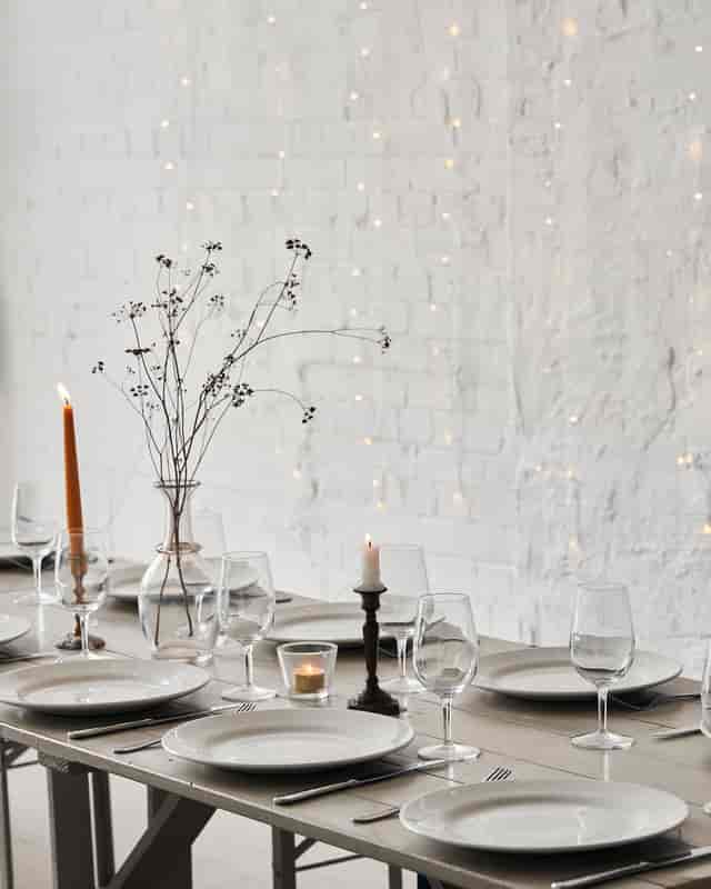 Minimalist autumn table setting with taper candles for industrial-chic wedding or event venue.