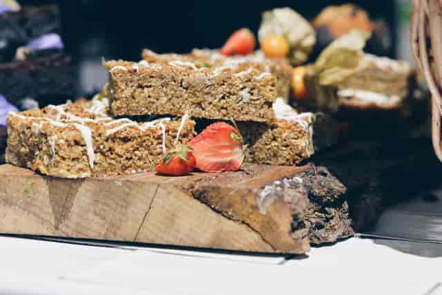 Autumn Yard dessert display with oatmeal bars, fresh strawberries, and rustic serving board.