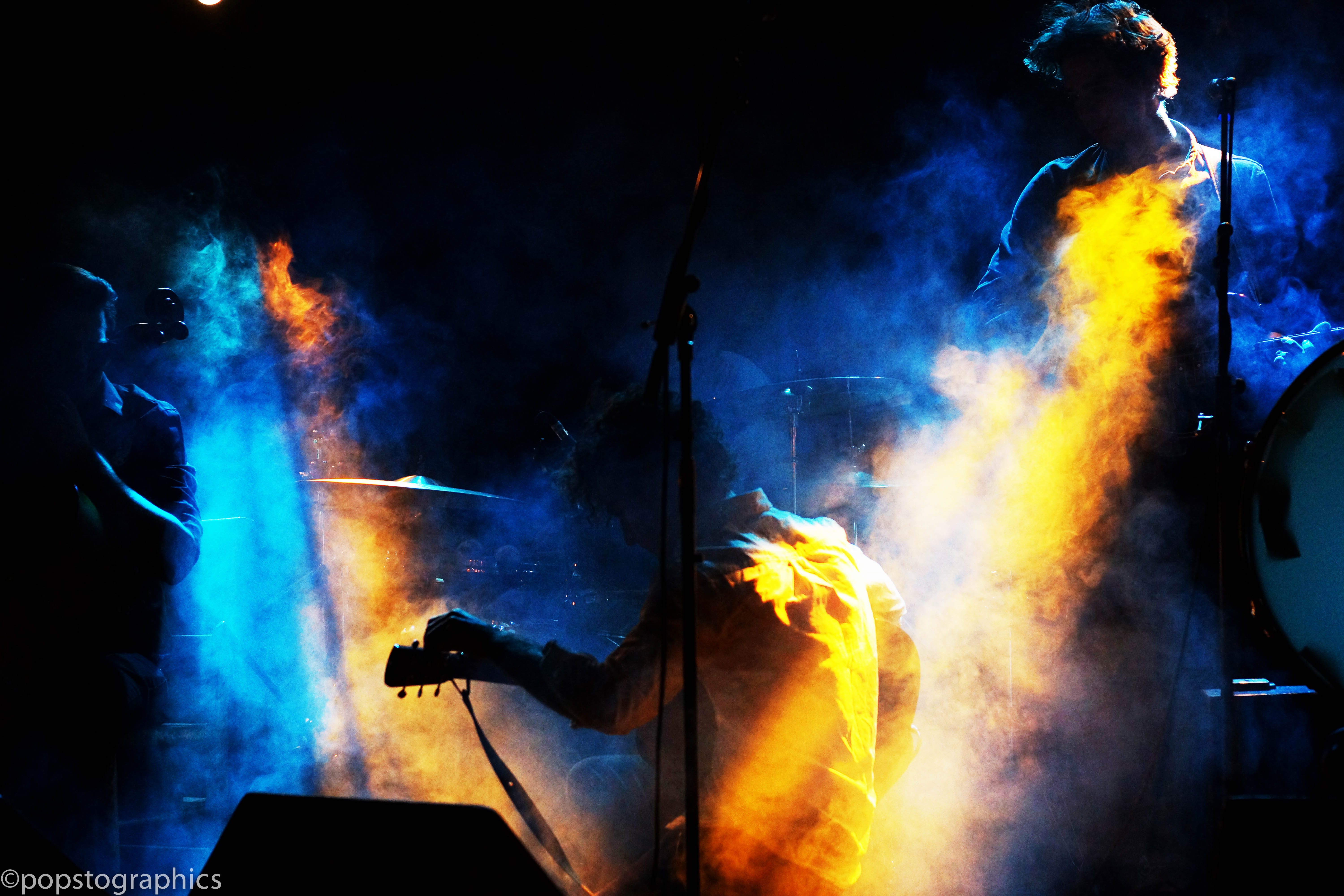 Dynamic live performance at Whole Venue, Nambucca with colorful lighting and smoke. - Banner