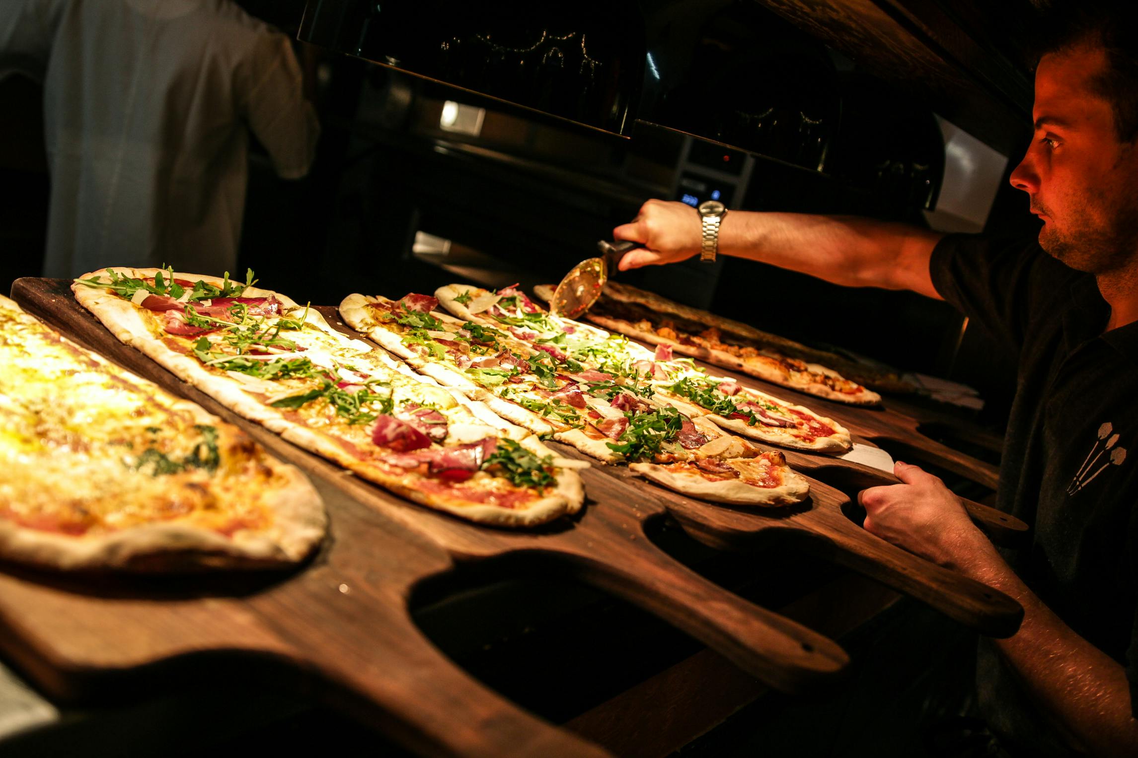 Artisanal pizza catering setup at Flight Club Bloomsbury for networking events.