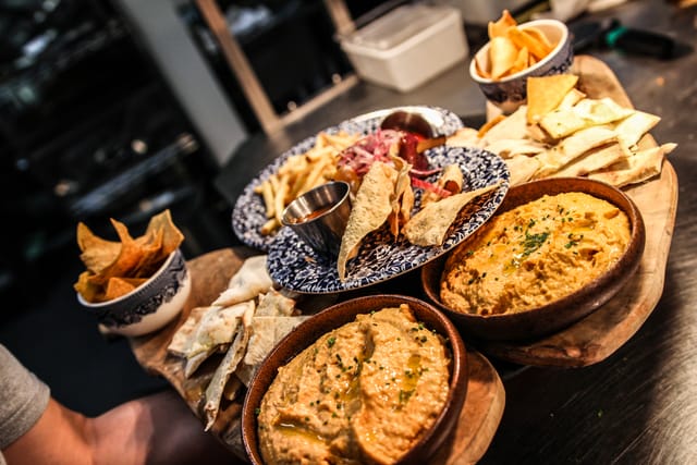 Appetizer platter with dips at Flight Club Bloomsbury for networking events and gatherings.