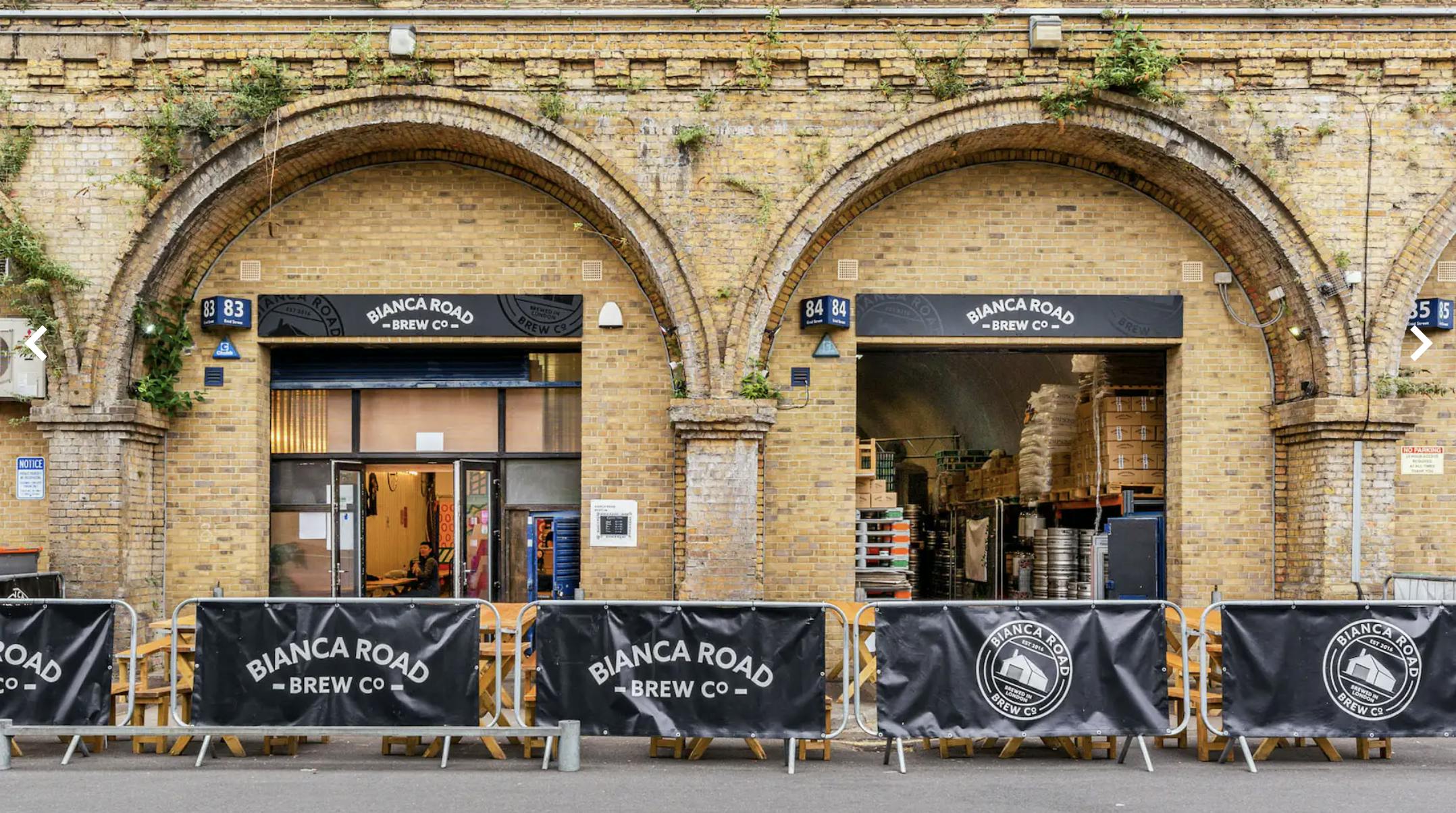 Brewery Tap Room with arched brick architecture, perfect for events and gatherings.