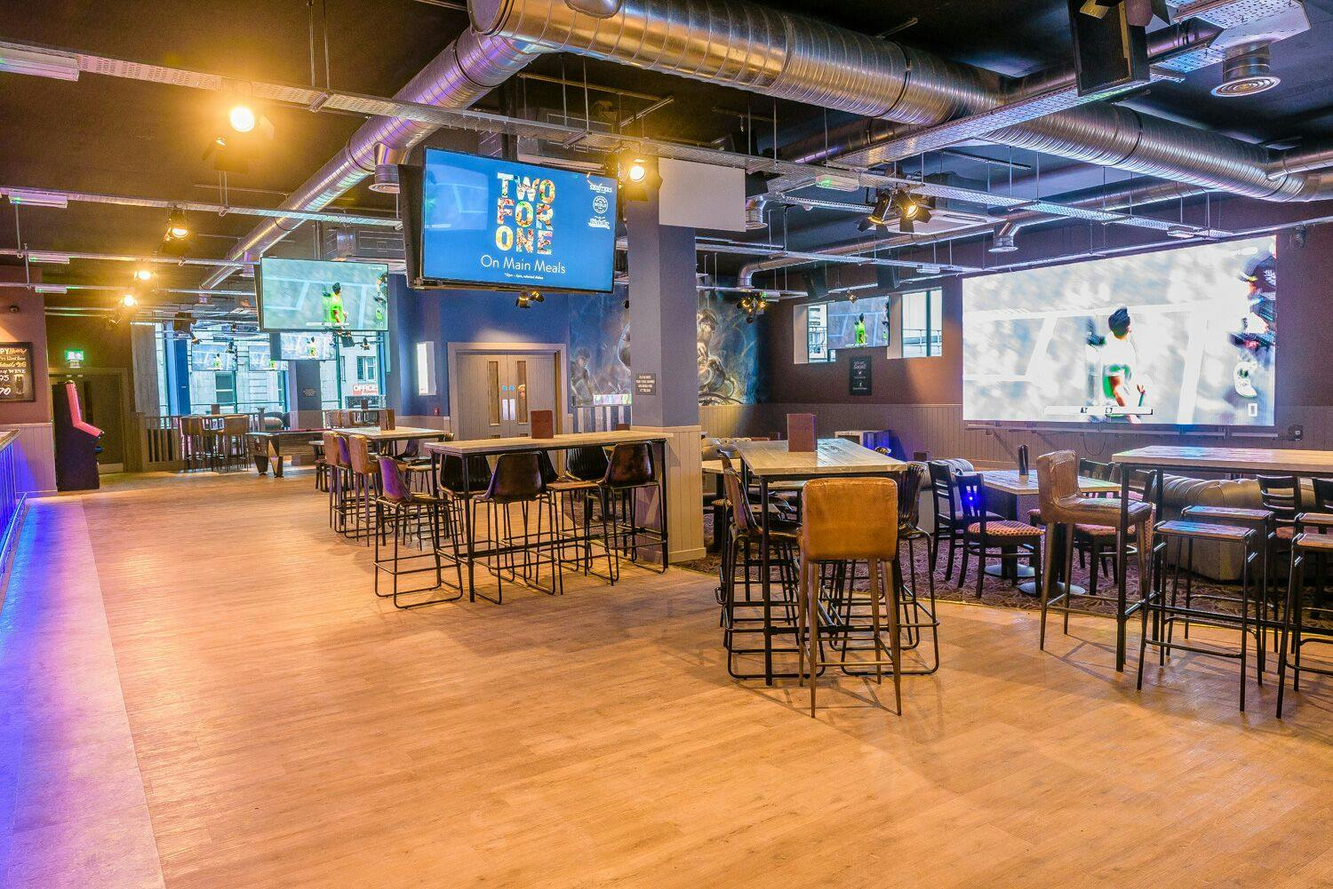 Shooters Sports Bar: modern event space with high-top tables for networking and gatherings.