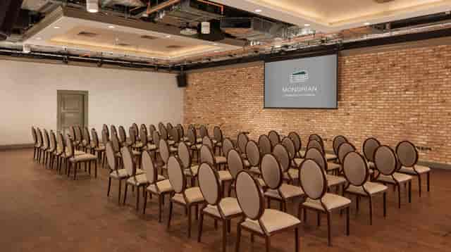 Modern meeting space in Virgin Hotels London with elegant circular chairs for conferences.