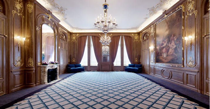 Elegant French Salon at Claridge's with ornate wood paneling for events and gatherings.