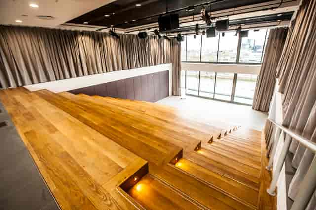 Modern amphitheatre with tiered seating, ideal for corporate events and performances.