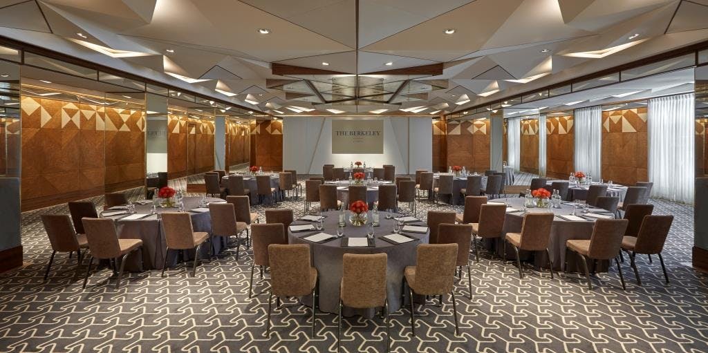 Elegant ballroom with round tables, perfect for corporate workshops and conferences.