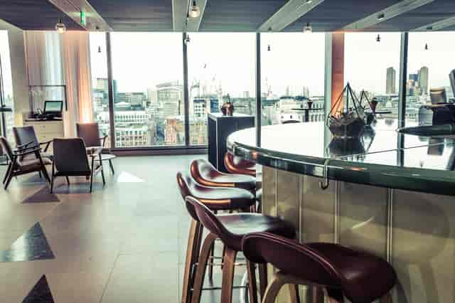 Cucumber event space with sleek furnishings and city views, ideal for networking and gatherings.