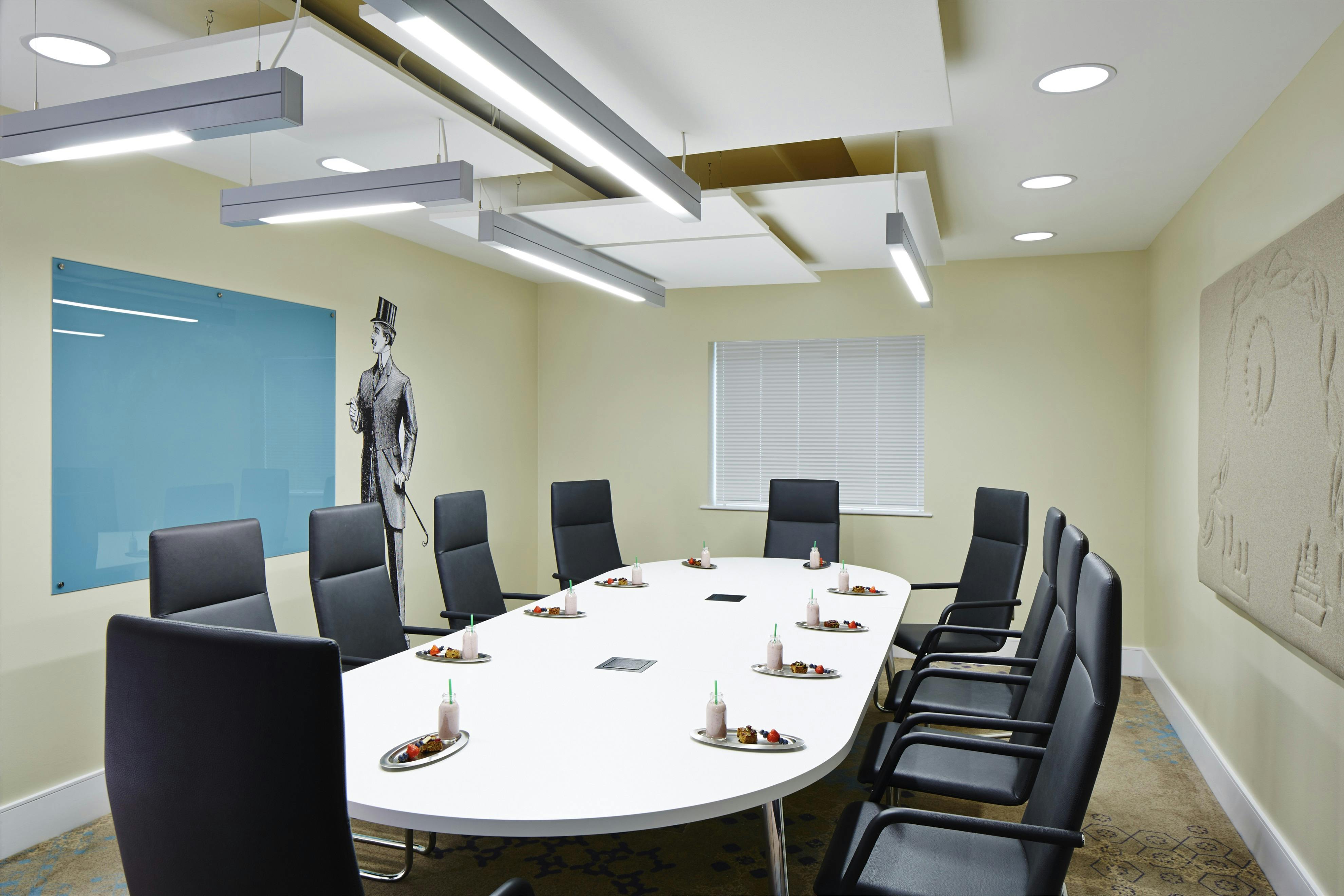 Modern conference room with oval table, ideal for corporate events in London Marriott Kensington.