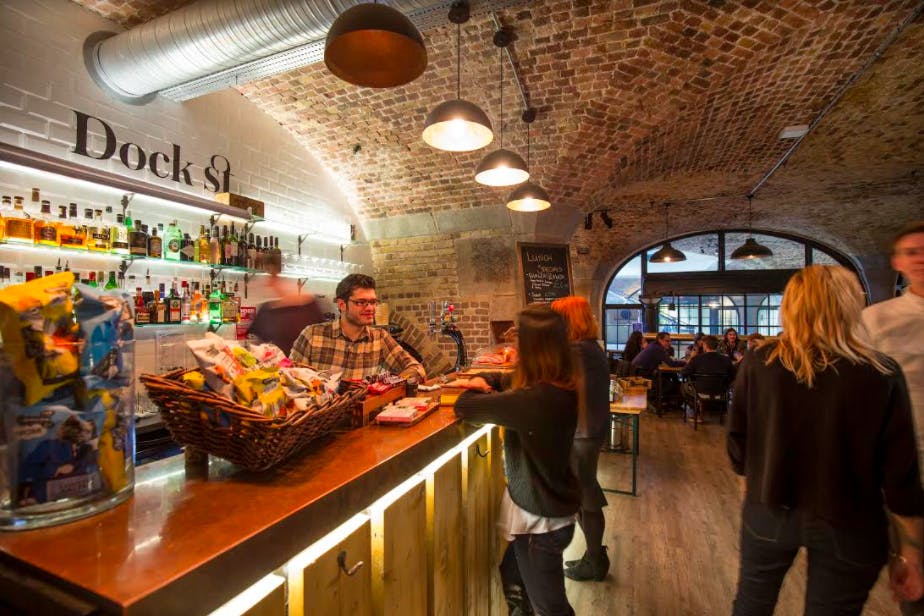 Vibrant Dock Street Bar with exposed brick, ideal for networking events and casual gatherings.