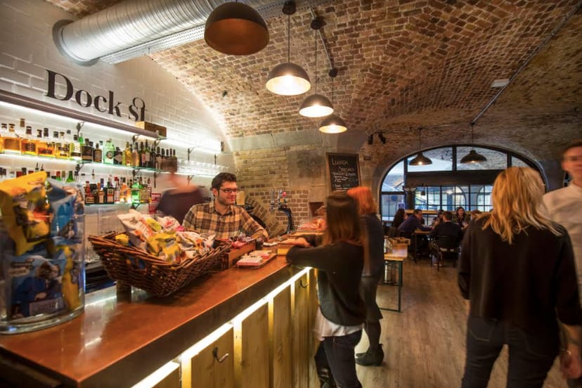 Vibrant Dock Street Bar with exposed brick, ideal for networking events and casual gatherings.