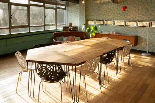 Stylish meeting space with wooden table and modern chairs at The Trampery Old Street.