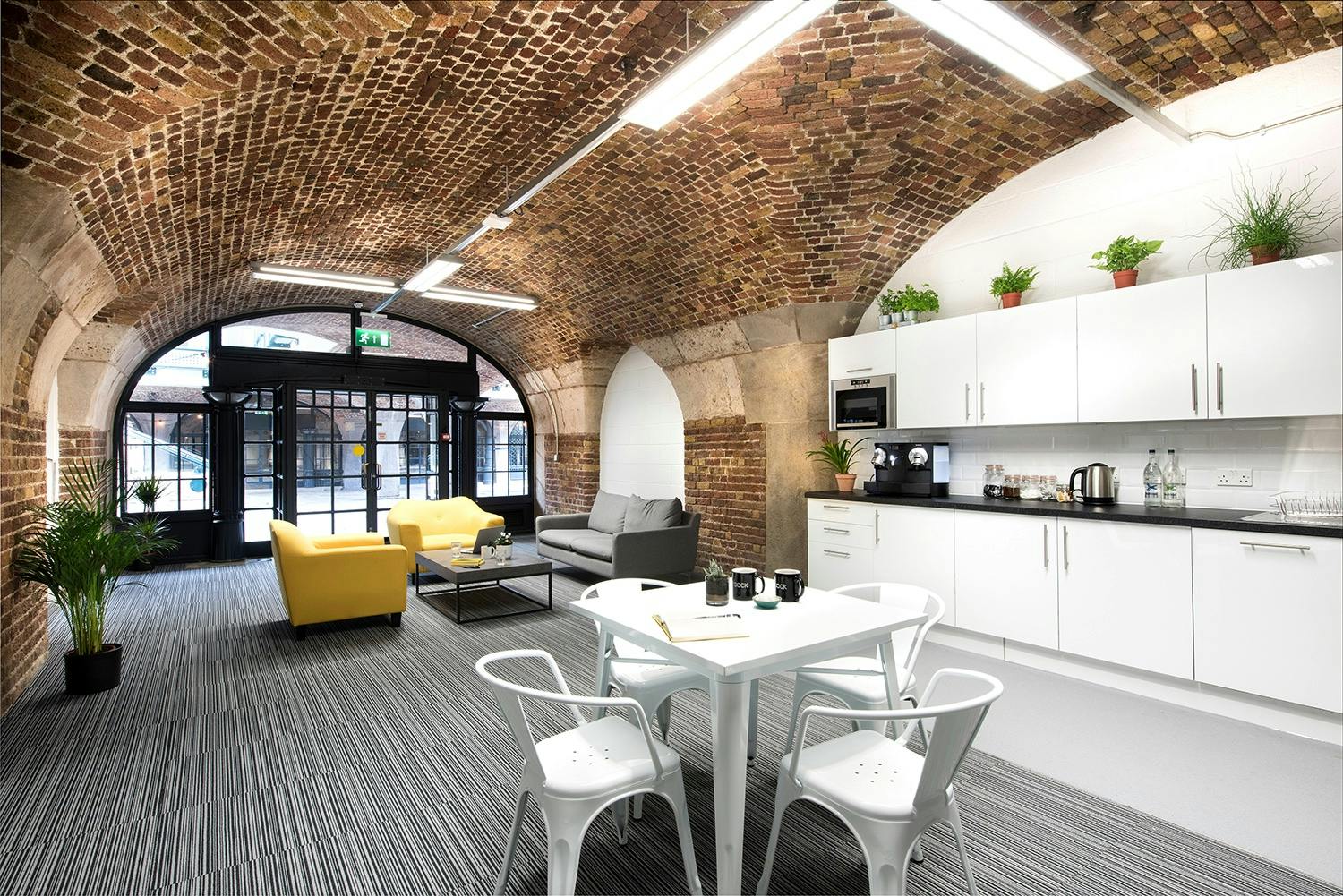 Modern meeting room with exposed brick, ideal for casual team events and brainstorming.