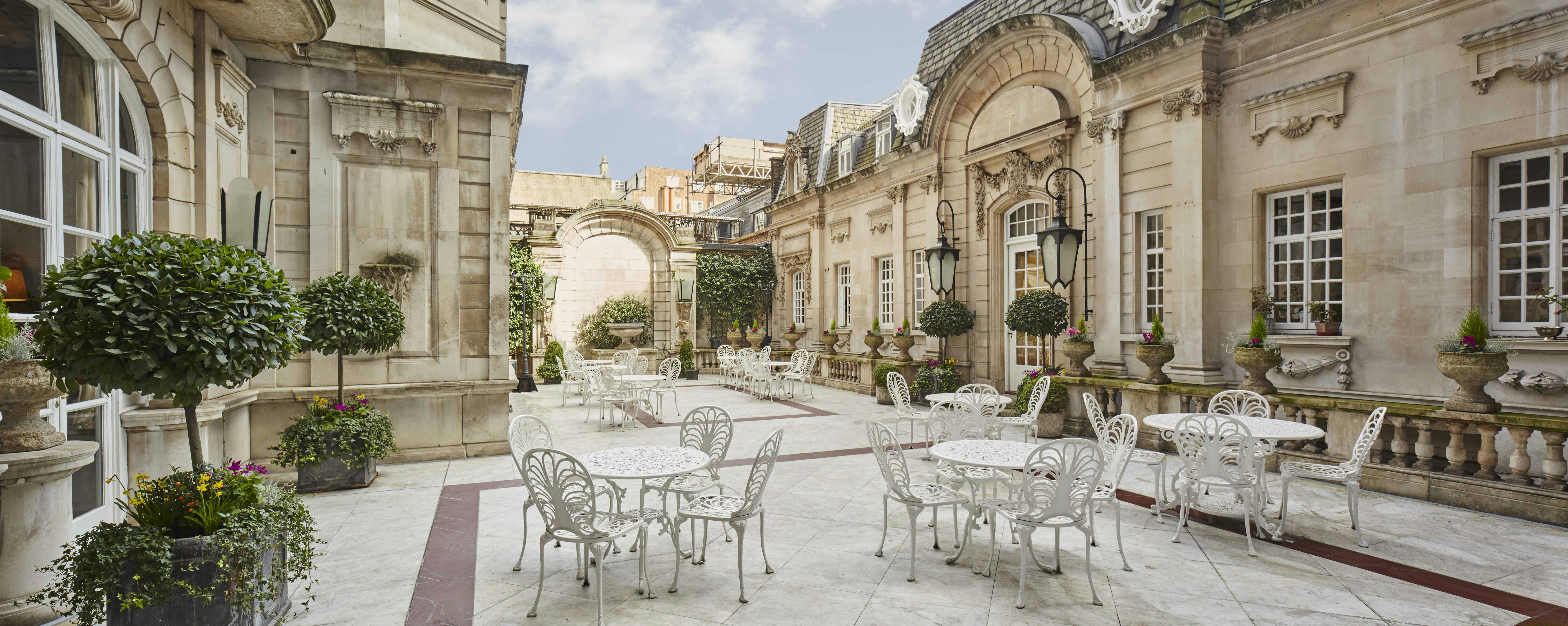 Elegant Dartmouth House courtyard with white tables, perfect for receptions and networking.