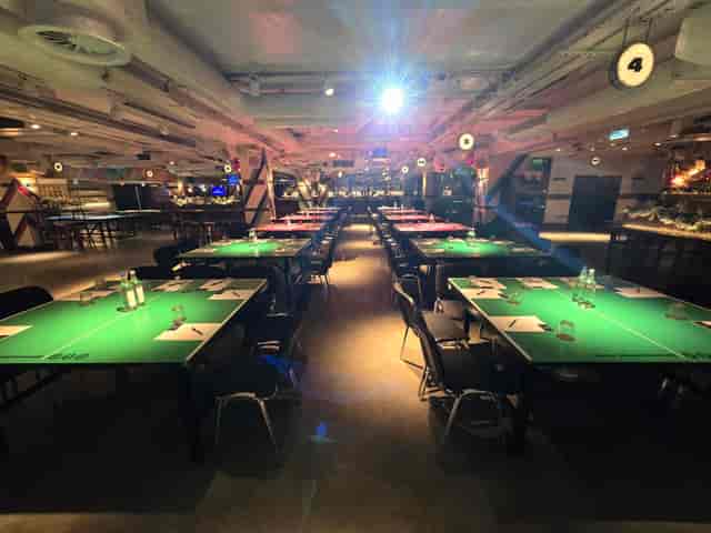 Industrial-chic meeting space with ping-pong tables for team-building and workshop events.