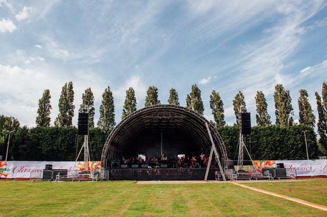 Athletics track in Wimbledon Park with stage, ideal for outdoor events and performances.