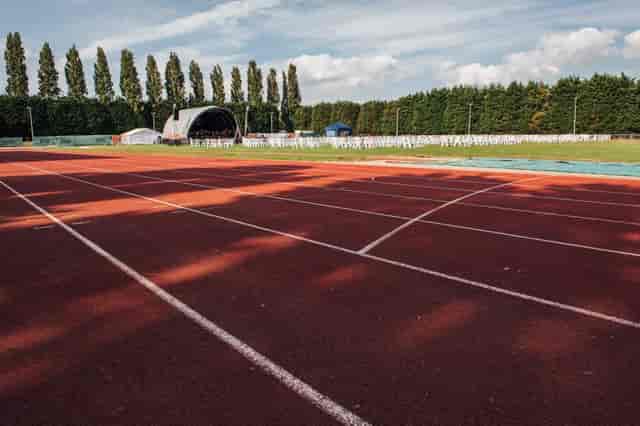 Athletics track in Wimbledon Park, ideal for sports events and concerts with lush greenery.