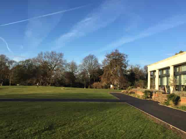 Main Lawn in Cannizaro Park, spacious venue for events with lush greenery and modern building.