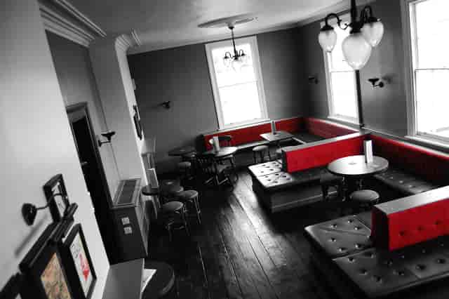 Intimate venue with red accents for small meetings and networking events in Eagle and Ball.