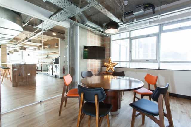 Modern meeting space with round table and natural light at The Trampery Old Street.