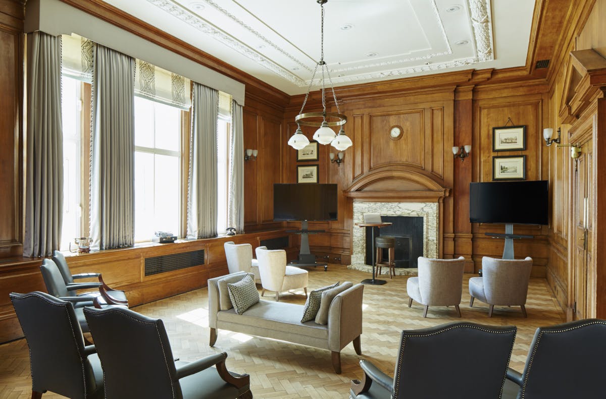 Herbert Morrison in a sophisticated meeting room with wood paneling at London Marriott Hotel.