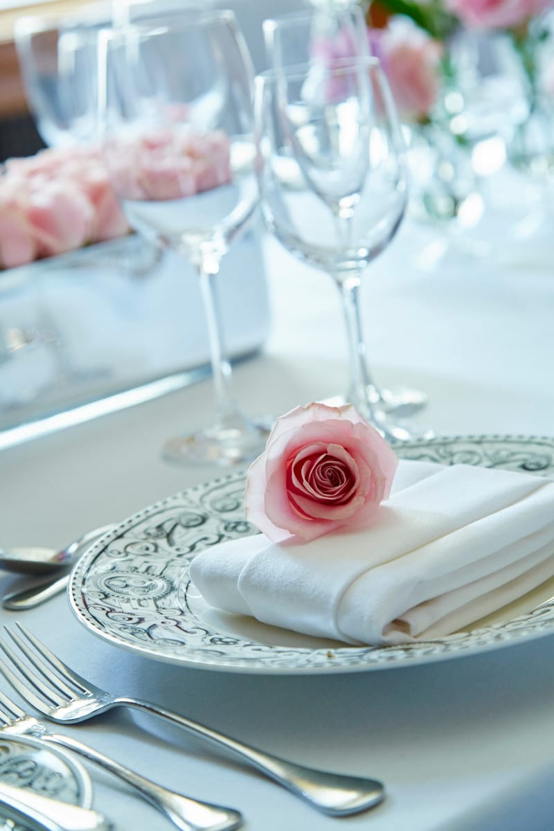 Elegant dining table with rose at London Marriott for upscale events and formal gatherings.