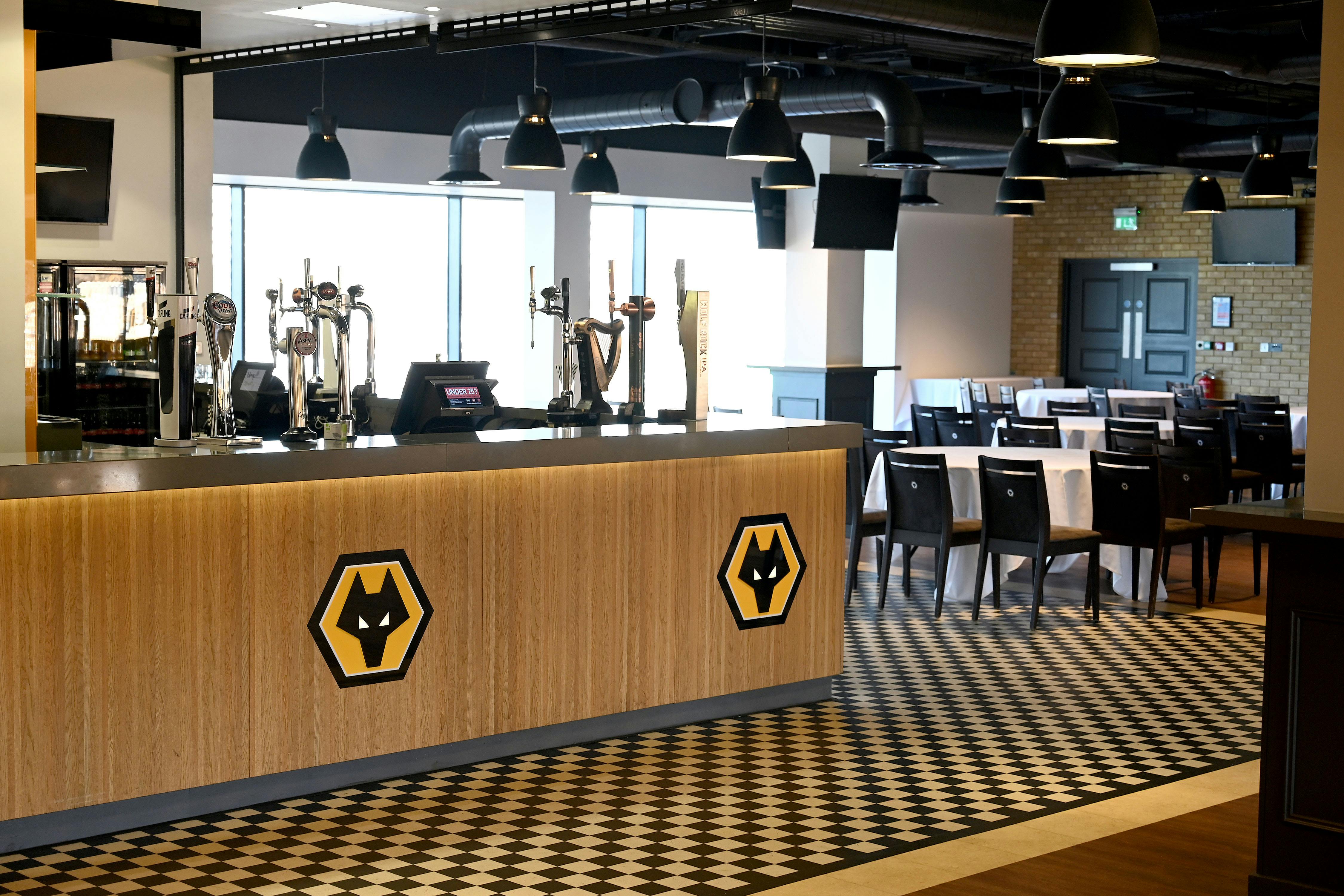 Modern event space at Molineux Stadium with stylish bar, ideal for networking and gatherings.