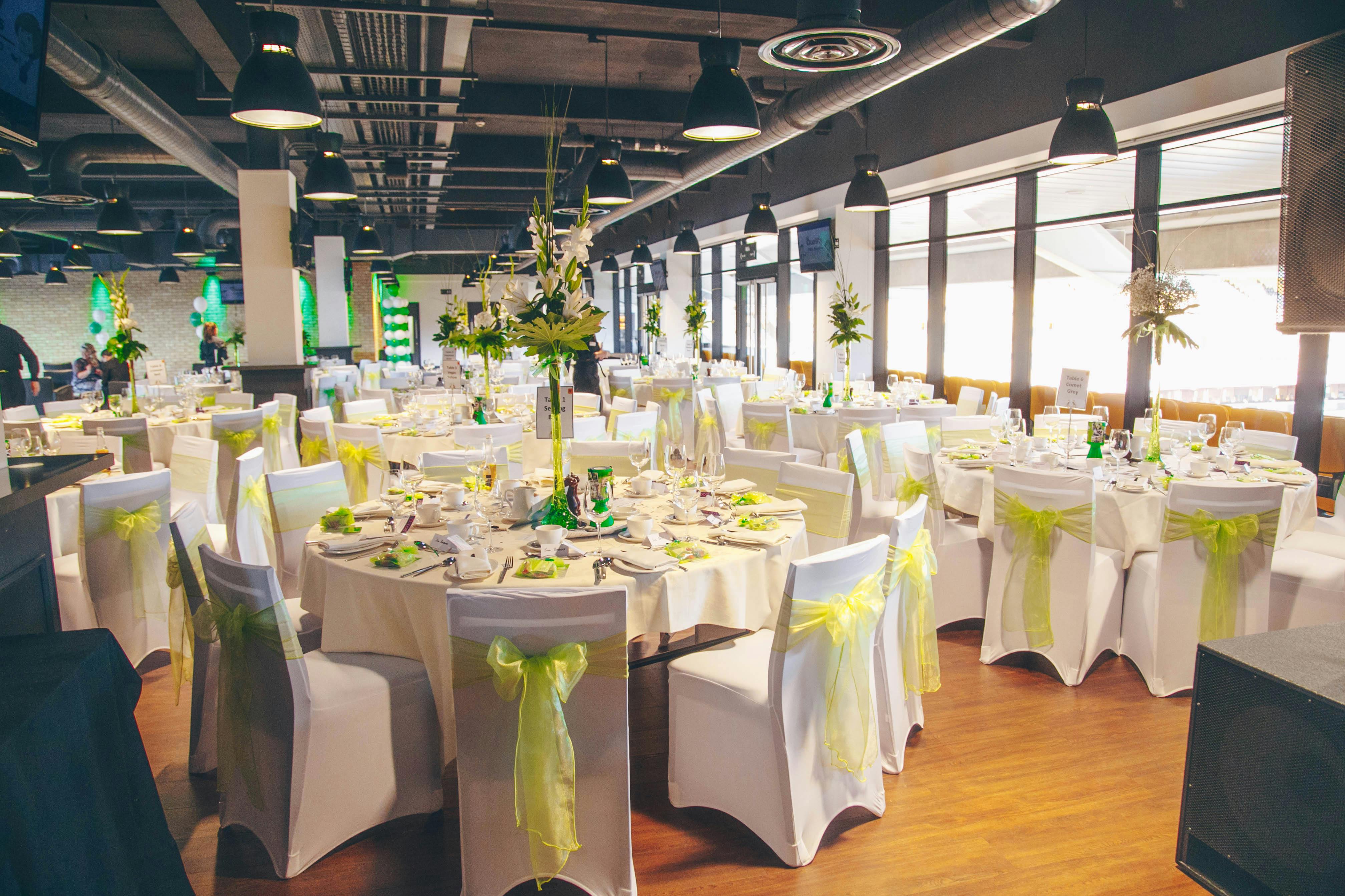 Elegant event space at Molineux Stadium with round tables for weddings and corporate events.