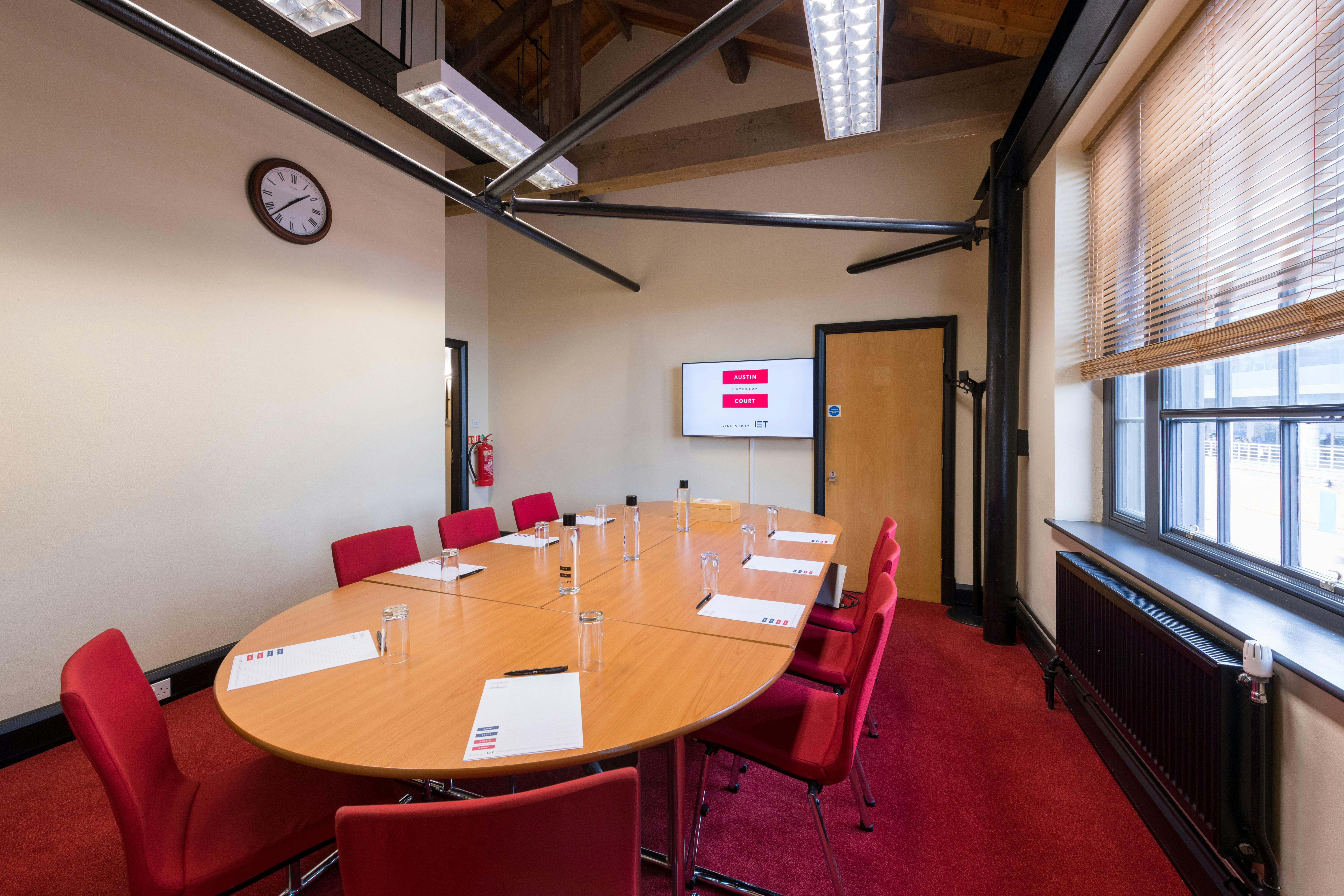 Boot Room at IET Birmingham: Austin Court, vibrant red chairs, ideal for meetings and presentations.