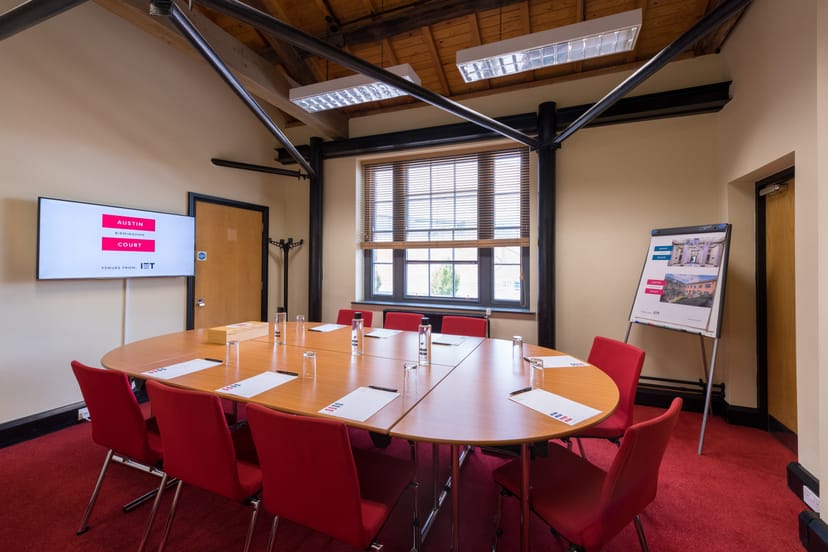 Boot Room at IET Birmingham: modern meeting space with round table for workshops.
