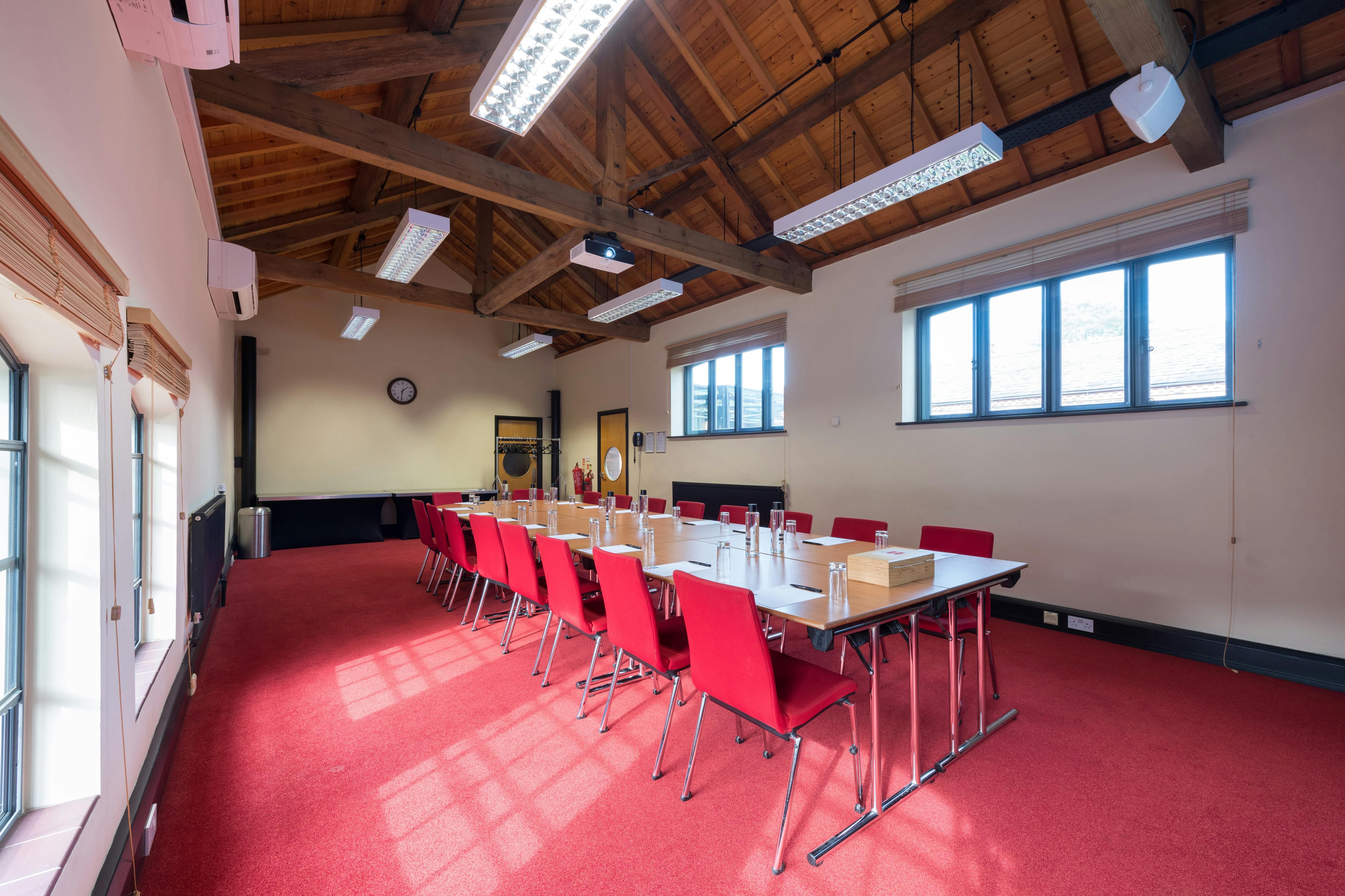 Crompton Room at IET Birmingham: corporate meeting space with red chairs, ideal for workshops.