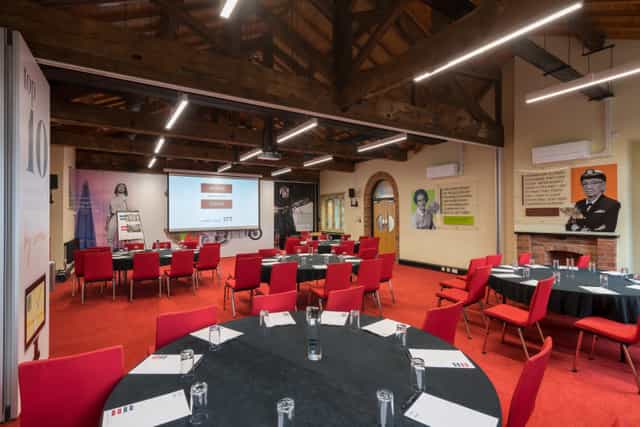 Lodge Room 1 at IET Birmingham: modern meeting space with round tables for events.
