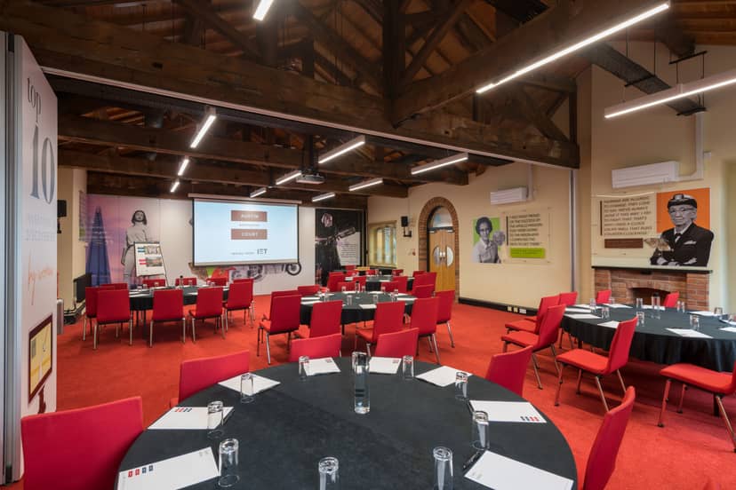 Lodge Room 2 at IET Birmingham: Austin Court, featuring round tables for conferences.