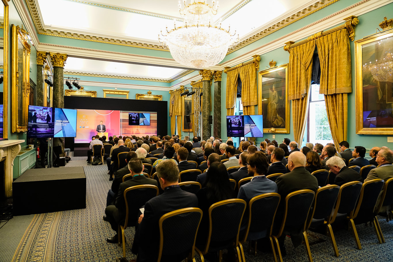 Nash Room conference setup at 116 Pall Mall with elegant decor and engaged audience. - Banner
