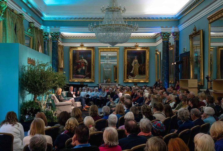 Panel discussion in Nash Room, 116 Pall Mall, featuring elegant decor and engaged audience. - Banner