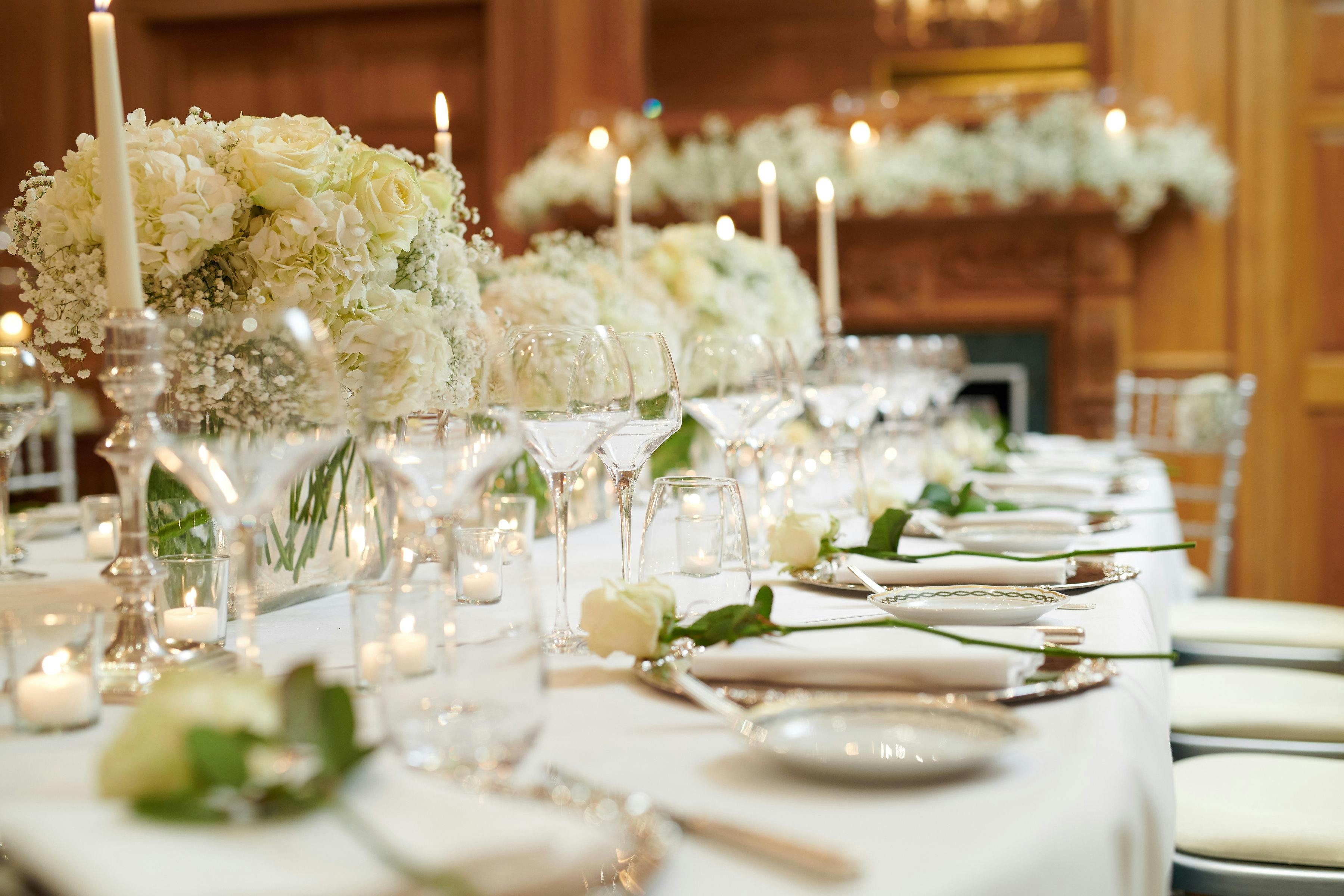 Elegant dining table with white florals for a luxurious wedding reception at The Milestone Hotel.